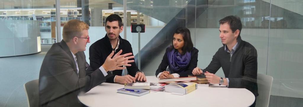 Researchers discussing in a bubble room