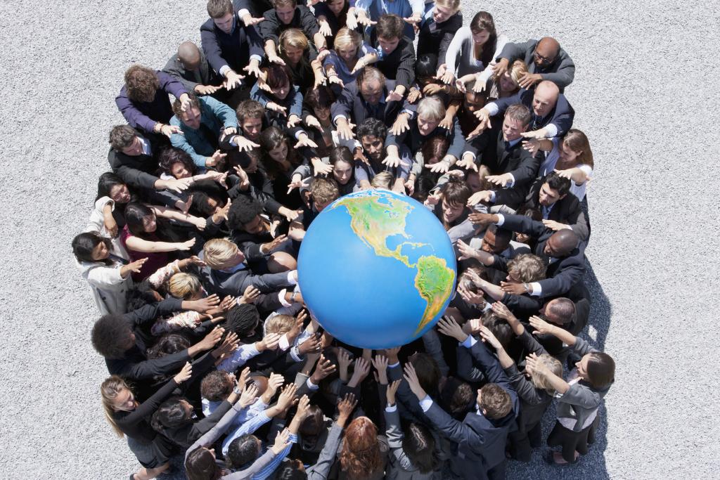 People gather together to hold a globe