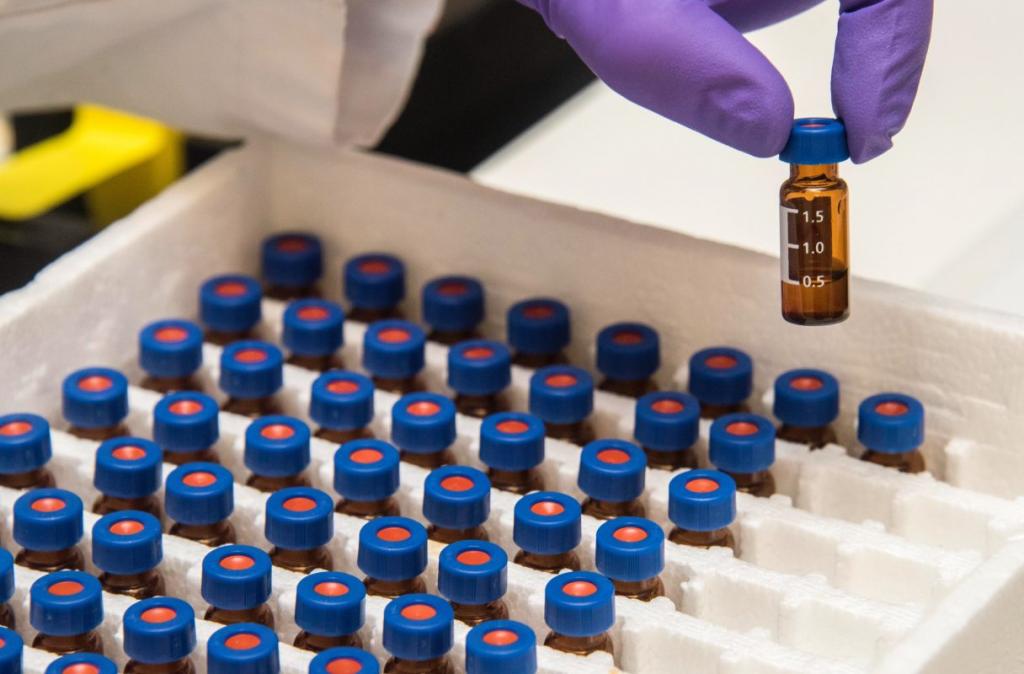 hand with gloves handling a box of vaccines