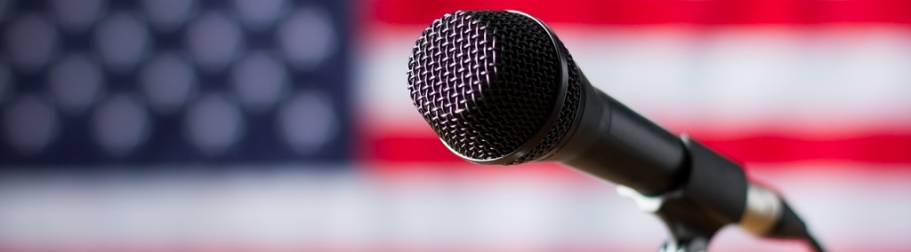  AHCD - shutterstock_418890733_American flag and microphone.png 