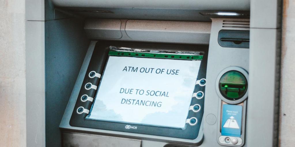 ATM with a message that reads "out of use due to social distancing"