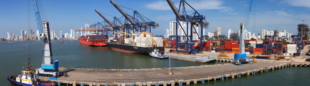 Panoramic view of a port activity with cargo ships, cranes and containers at the pier of the port of Cartagena, Colombia.