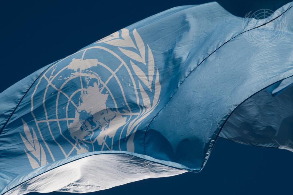A view of the flag of the United Nations that flies in front of UN Headquarters in New York. With its white emblem on a light blue field, the flag symbolizes the union of all people in search of a permanent, durable peace. 