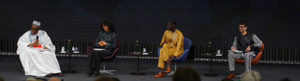 Students Micol Ambroso and Abdourahmane Diaw siti with professor Eric Degila for an event on African multilateralism 