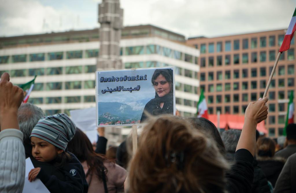 european protestors hold signs for mahsa amini