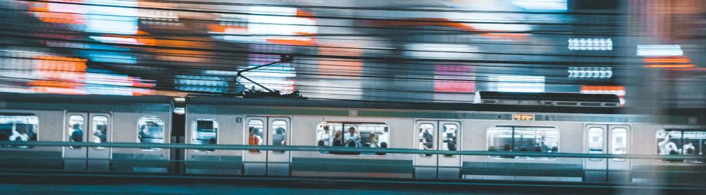 Tokyo train rushing through city.