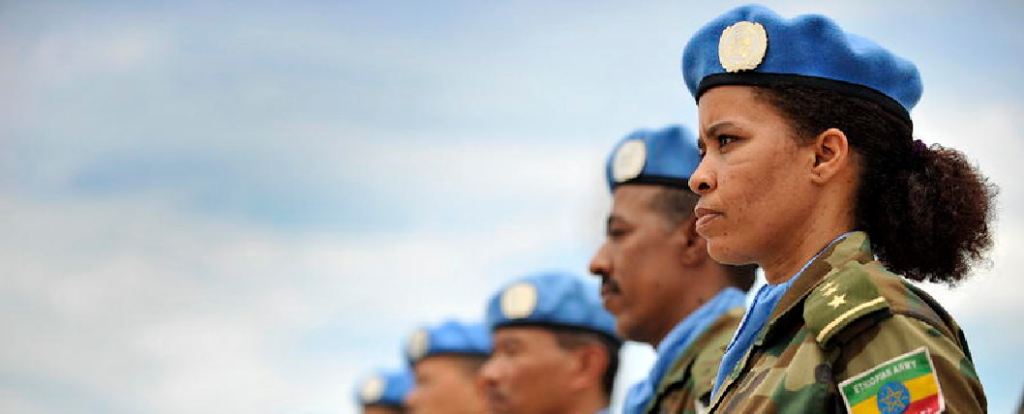 A female member of the Ethiopian battalion of the United Nations Mission in Liberia (UNMIL) joins the military observers in a parade to receive the medals in recognition of their contribution to the mission. 
