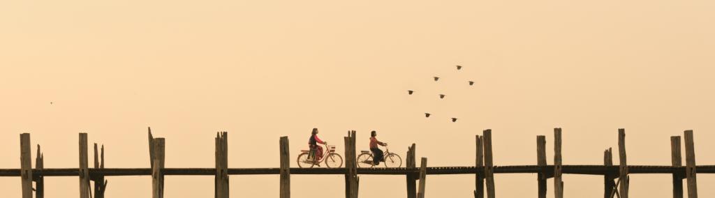 Two bikers on a bridge