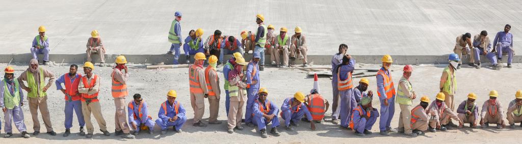 South-Asian construction workers take a break following their morning shift in Duqm, Oman