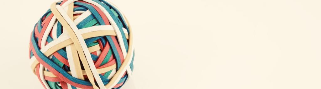 Rubber band ball made from many colourful elastic bands.
