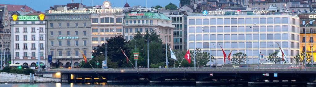 Old town cathedral and waterfront luxury brand offices in Geneva, Switzerland. 