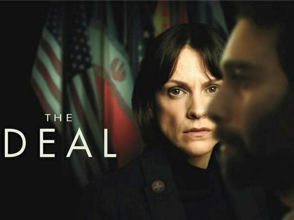A serious-looking woman stands in focus with flags behind her, evoking a diplomatic theme. A blurred man is in the foreground. The text reads "The Deal."