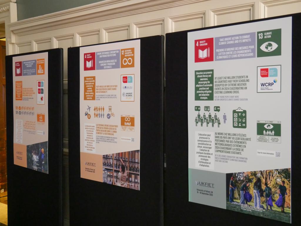 Three informational posters on display boards highlight themes like education and climate action. Bright colors and icons emphasize the sustainable goals.