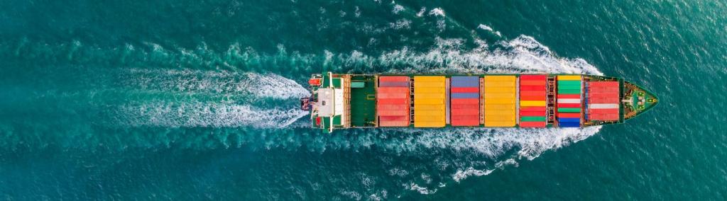 Aerial top view of cargo ship with contrail in the ocean