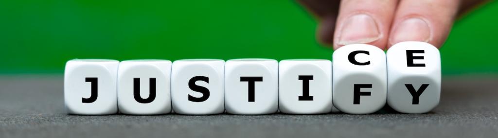 Hand turns dice and changes the word “justify” to “justice”.