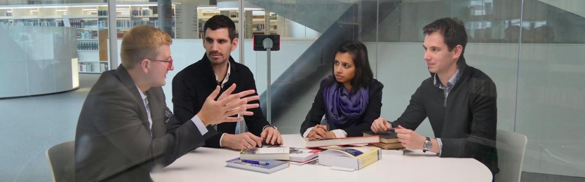 Researchers discussing in a bubble room