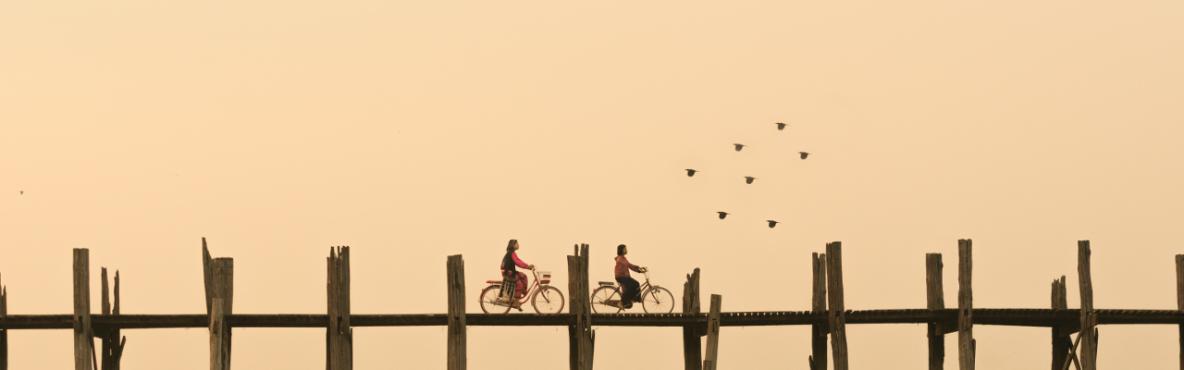 Two bikers on a bridge