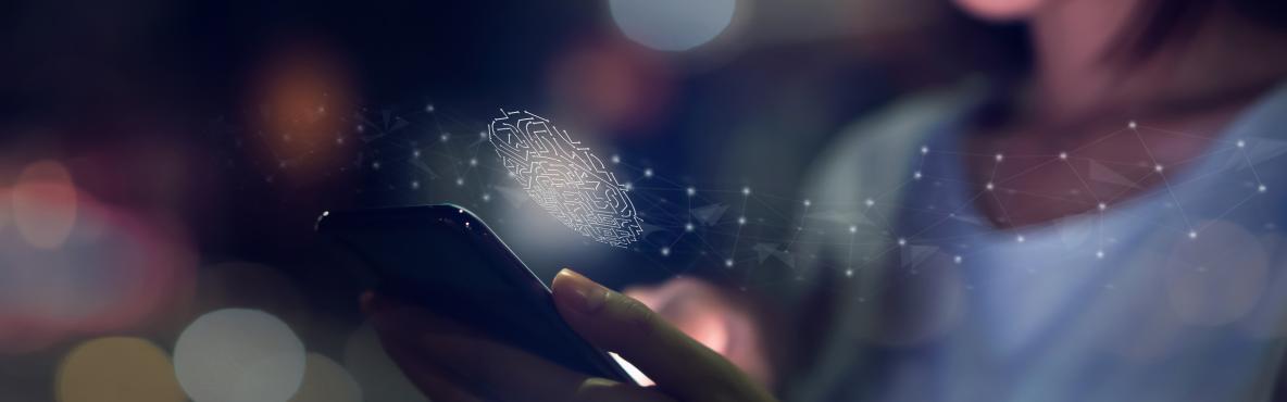 A woman smiles while using a smartphone, with a digital fingerprint hologram above it. The image conveys a sense of technology and security.