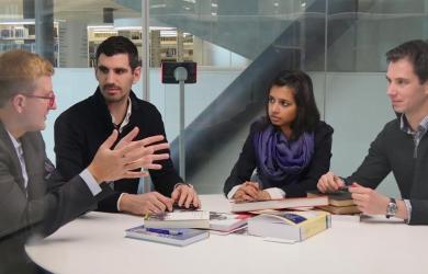 Researchers discussing in a bubble room