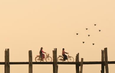 Two bikers on a bridge