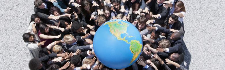 People gather together to hold a globe