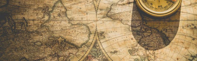 upside down world map with a compass on top