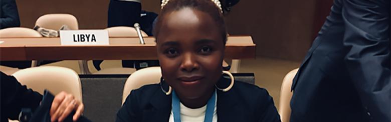 Lenias smiles sitting at the United Nations