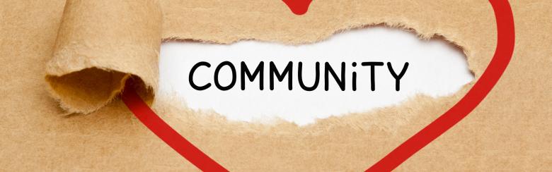 the word community is written in a heart