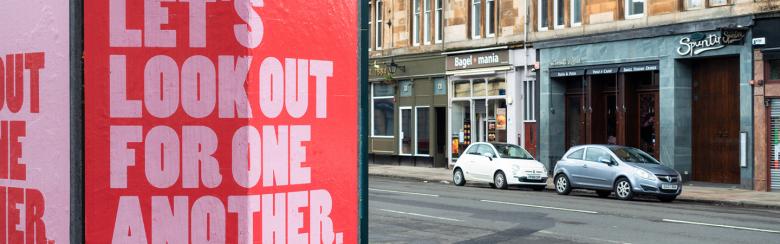 A sign reads Let's look out for one another. 