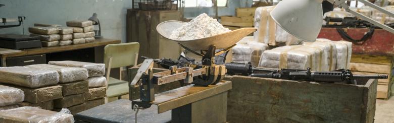 Packages of cocaine stacked in an empty warehouse