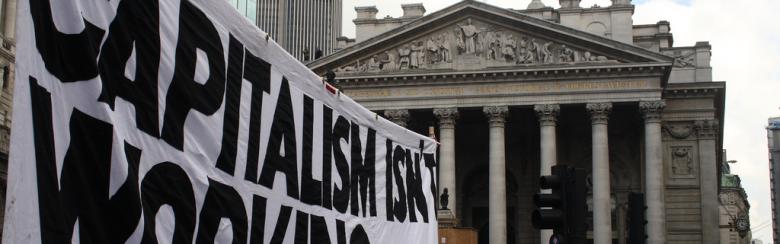 Demonstration sign that reads "Capitalism isn't working"