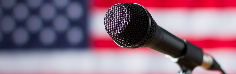  AHCD - shutterstock_418890733_American flag and microphone.png 