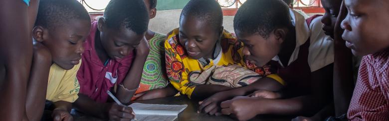Children in their school classroom working on an essay, Mzuzu, Malawi.