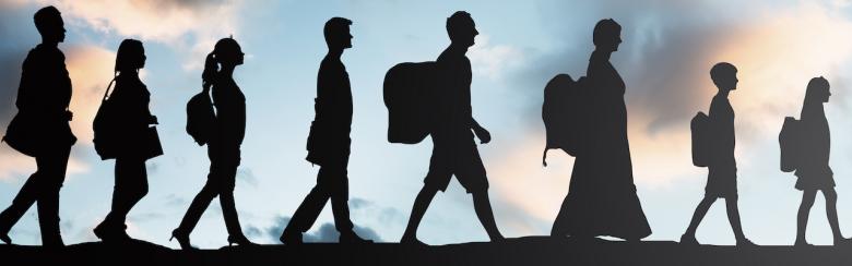 Silhouette of refugee people with luggage walking in a row.