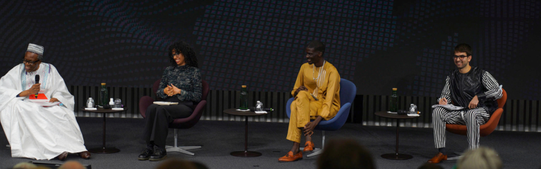 Students Micol Ambroso and Abdourahmane Diaw siti with professor Eric Degila for an event on African multilateralism 