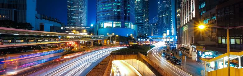 A night scene with a highway and city lights