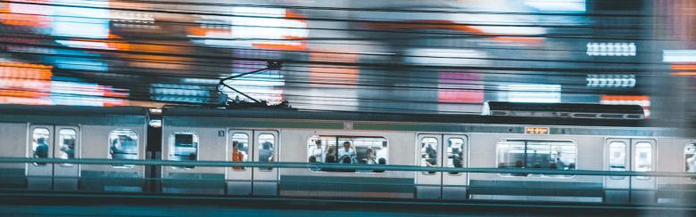 Tokyo train rushing through city.