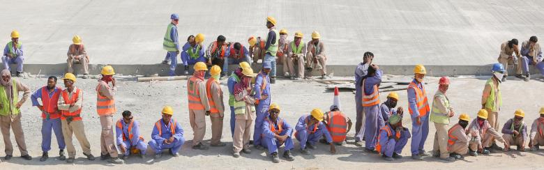 South-Asian construction workers take a break following their morning shift in Duqm, Oman