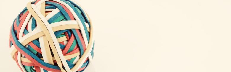 Rubber band ball made from many colourful elastic bands.