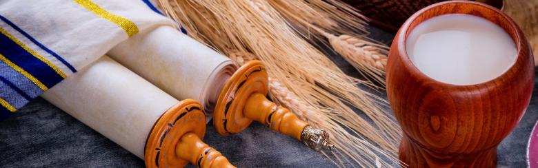 Jewish holiday Shavuot for kosher set dairy food on torah scroll and tallis.