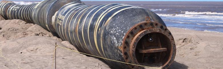 Abandoned gas pipeline on a coastline