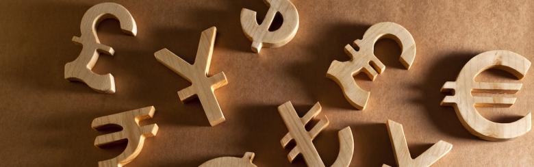 Wooden currency units on a craft background