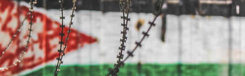 Palestine Flag through barbed wire in Old city of Hebron, Palestine