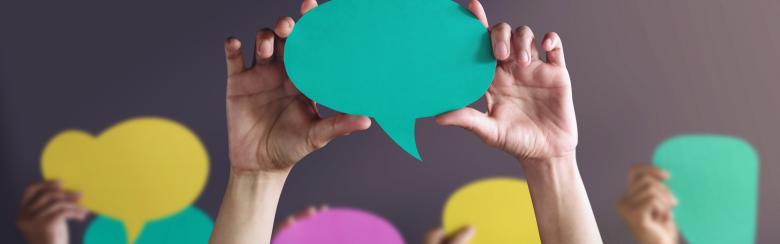 Hands holding speech bubbles 