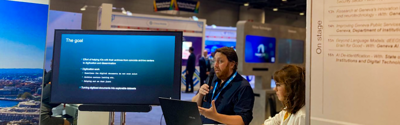 Florian Cafiero presents standing in front of a screen in the middle of a conference centre