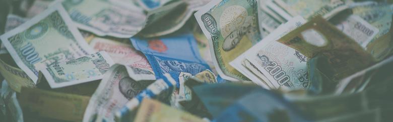 A close-up view of diverse international currency banknotes in soft focus, conveying wealth and finance themes.
