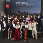 A group of students stands and makes funny faces and movements