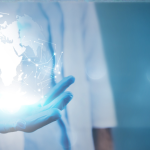 A person in a lab coat holds a glowing digital globe with network connections, symbolizing health innovation and global connectivity, against a blue background.